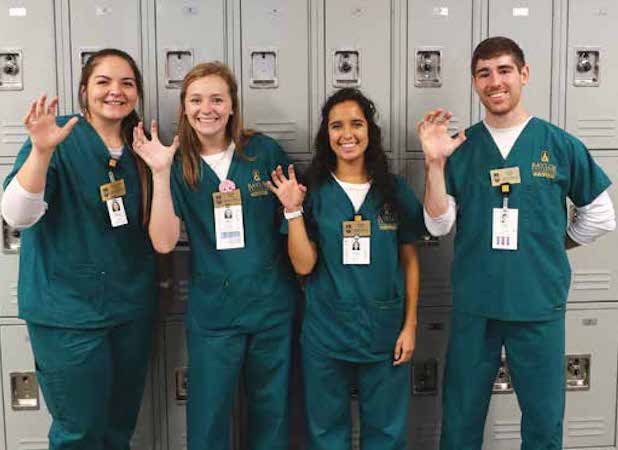 Nursing Students with Sic Em hand sign